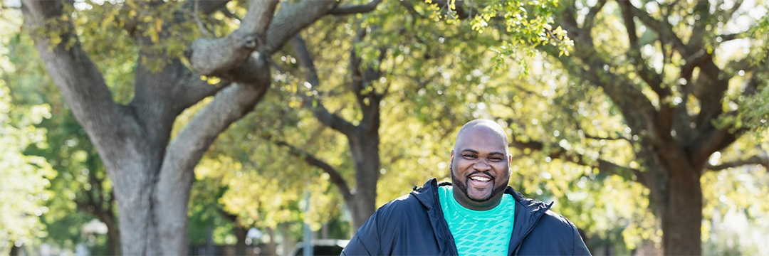overweight man smiling while exercising