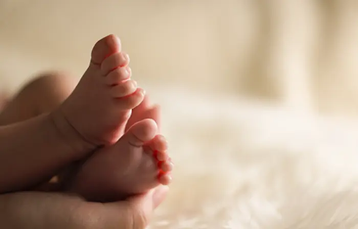 Baby feet on plush white blanket